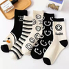 Socks Women′s MID-Calf Socks Smiley Cute Personality Ins Tide Black and White Colors Long Socks Sweet Cartoon Girls Sports Socks